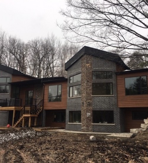 Riverfront Renewal: New Build, Old Foundation, Basement Preserved